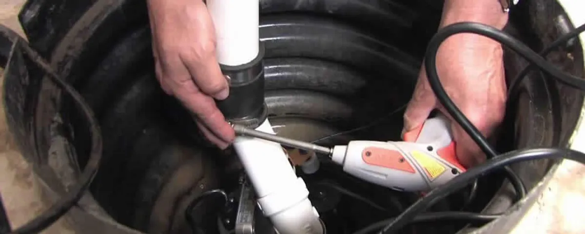 Sump pump installation technician connecting PVC discharge piping in Dallas, TX